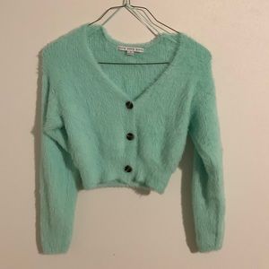 Blue teal color fuzzy shirt.